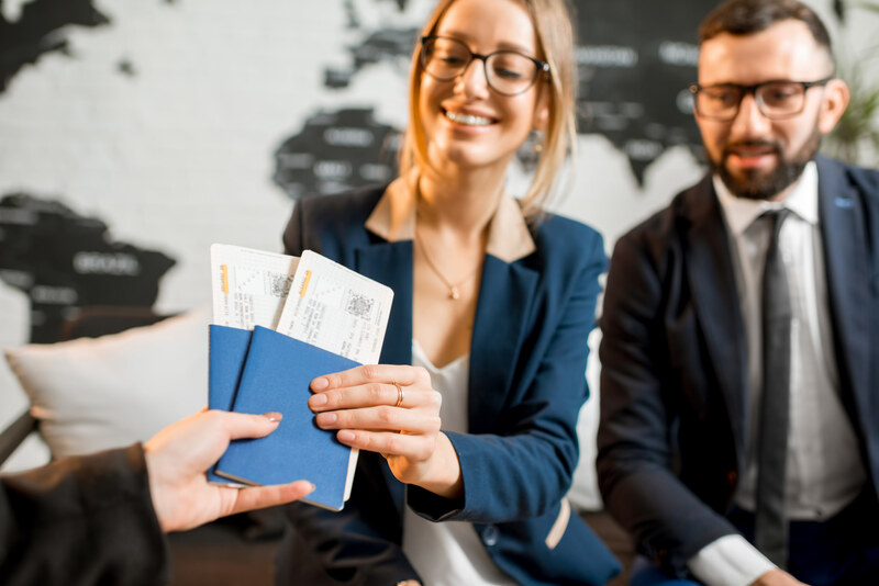 Happy couple holding their passports with approved visas, representing success in the U.S. visa interview process.