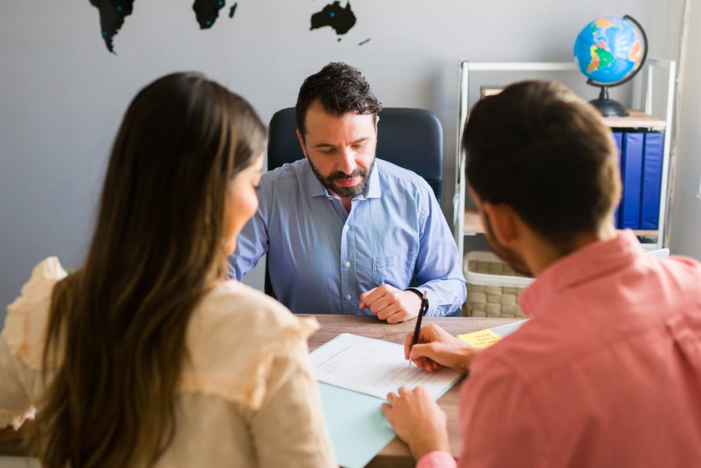 Couple being advised by an attorney in preparation for the U.S. Embassy interview, symbolizing the visa application process