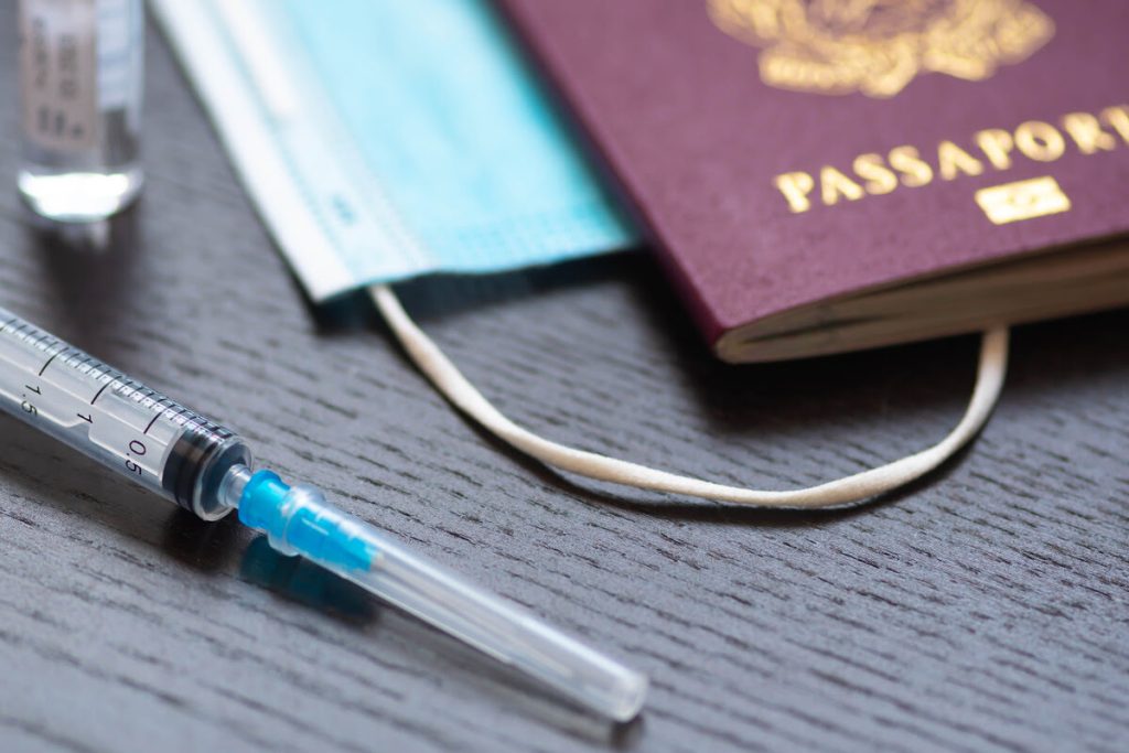 Syringe, medical mask, and passport—essential elements in the visa process for foreign doctors seeking employment in the U.S.